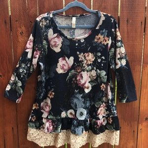 Large floral knit top with lace trim underneath.